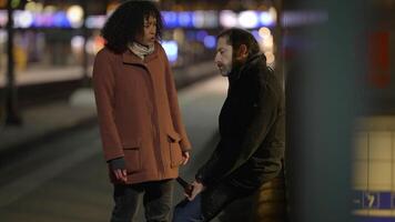 An Intimate and Thoughtful Conversation Taking Place at Night on a Train Platform video