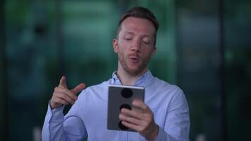 A person on a call using a tablet, showing interest and attentiveness in communication video