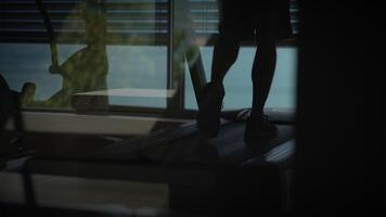 A person walks on a treadmill while enjoying the beautiful view outside their window video