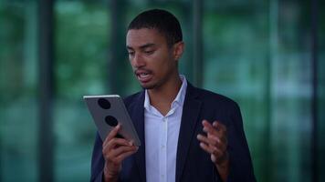 A person on a call using a tablet, showing interest and attentiveness in communication video