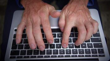 Hands are actively typing on a laptop keyboard, demonstrating various digital skills video
