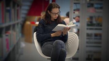 An Engaged and Focused Reader in a Contemporary Library Setting with Various Resources video