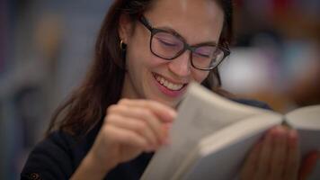 A Joyful Reader Deeply Enjoying a Captivating Book in a Cozy, Inviting Environment video