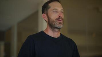A Thoughtful Man in a Modern Indoor Setting, where he reflects on his contemplative thoughts video