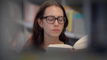 A Focused Reader Engaging Deeply in the Library Surrounded by Their Favorite Book video