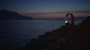 A Serene and Peaceful Evening by the Ocean Featuring an Artistic Sculpture in a Beautiful Setting video