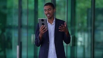 A person on a call using a tablet, showing interest and attentiveness in communication video