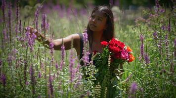 A captivating woman stands gracefully in a beautiful flower field surrounded by a bouquet of roses video