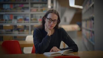 A focused reader in a calm library setting, deeply engaged with an interesting book video