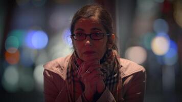 A Thoughtful and Contemplative Woman in a Vibrant Urban Setting Surrounded by Stunning Bokeh Lights video