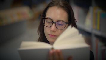 A Focused Reader Completely Immersed in an Engaging Book at the Local Library Environment video