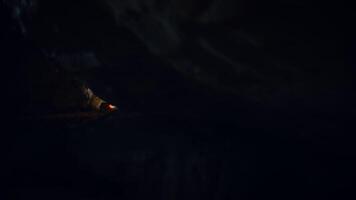 A Mysterious Cave with Dim Light Reflection That Evokes Curiosity and Intrigue Around It video