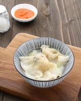 Yummy Wonton Soup or dumpling soup or Pangsit Kuah, served in bowl. photo