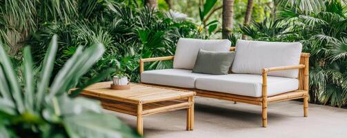 Stylish outdoor sofa in a tropical setting surrounded by lush green plants, perfect for relaxing moments and cozy gatherings. photo