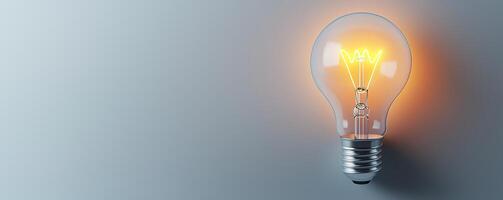 Bright light bulb glowing against a simple gray background, symbolizing ideas, innovation, and creativity. photo