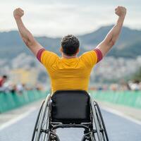 Joyful athlete in a wheelchair celebrating victory on a track. photo