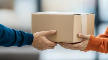 Two hands exchanging a cardboard package, soft focus background. photo