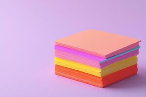 Colorful stacked paper sheets on a lilac background. photo