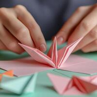 Hands crafting a colorful origami flower, soft focus, calming workspace. photo