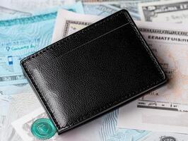 Black wallet with cash and documents, close-up shot, isolated background. photo
