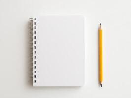 Blank notebook with pencil on white isolated background. photo
