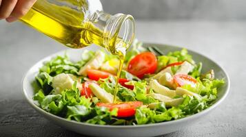 Fresh salad with olive oil being poured, vibrant colors, healthy eating. photo