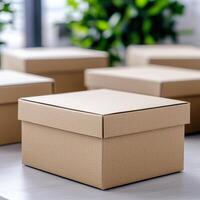 Brown cardboard box on a table with greenery in the background. photo