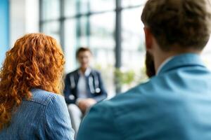 Group of people engaged in a serious discussion in a modern setting. photo