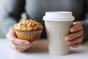 Muffin and coffee cup held together, white background. photo