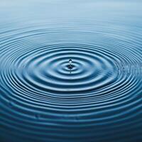 Water ripples creating a serene blue surface pattern. photo