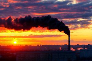 Smoke billowing from a factory chimney at sunset, vibrant sky, industrial silhouette. photo