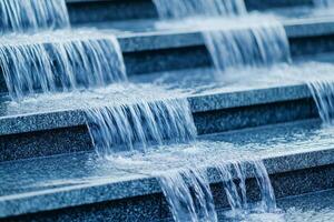 Water cascading over sleek stone steps, creating a serene and calming atmosphere. photo