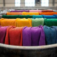 Vibrant rolls of fabric organized in a circular display in a textile factory. photo