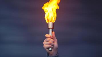 Hand holding a torch with a bright flame against a blurred background. photo