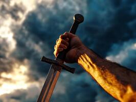 A raised sword against a dramatic cloudy sky. photo