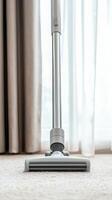 Vacuum cleaner head on carpet, bright natural light filtering through curtains. photo