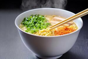 Delicious bowl of steaming ramen with green onions and spices. photo