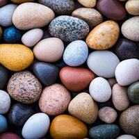 Colorful and smooth pebbles arranged in a natural pattern, close-up view. photo