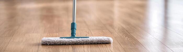 Cleaning tool on wooden floor, showcasing a tidy home environment. photo