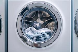 Washing clothes in a modern washing machine, front view with transparent door. photo