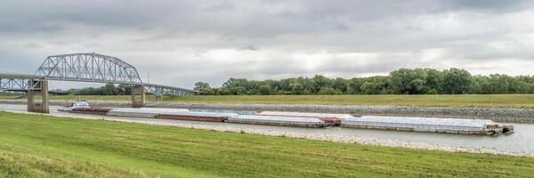 Towboat with barges is passing under a bridge on the Chain of Rocks Canal of MIssissippi River above St Louis photo