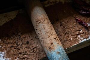 Grinding cacao beans with chili peppers photo