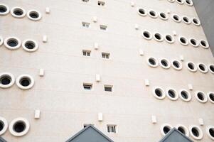 Modern architectural facade with circular windows in geometric pattern photo