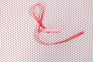Pink Ribbon on Polka Dot Background photo