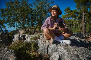 Woman with camera enjoying nature in a rocky outdoor setting photo