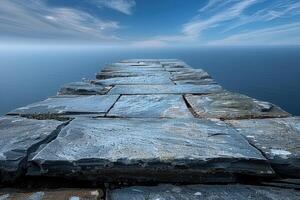 A Crumbling Stone Pathway Extending into the Mist-Covered Sea photo