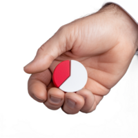 Close-up of a hand holding a small red and white pie chart segment on a transparent background png