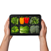 Hands holding a tablet displaying colorful vegetables like bell peppers and broccoli on a transparent background png