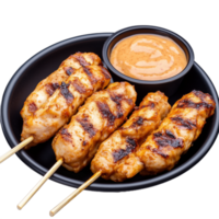 Grilled chicken skewers with spicy dipping sauce on black plate png