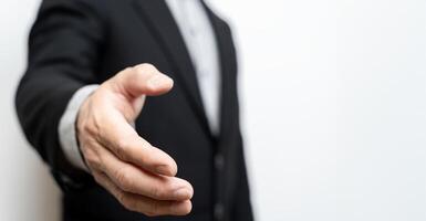 Businessman with open hands ready to seal an agreement, partners shaking hands, shaking hands, copy space. Business and office concept. photo